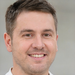 Joyful white adult male with short  brown hair and brown eyes