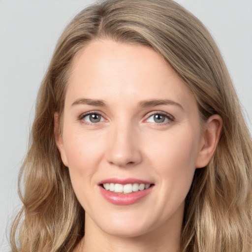 Joyful white young-adult female with long  brown hair and grey eyes