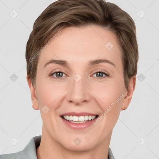 Joyful white young-adult female with short  brown hair and grey eyes