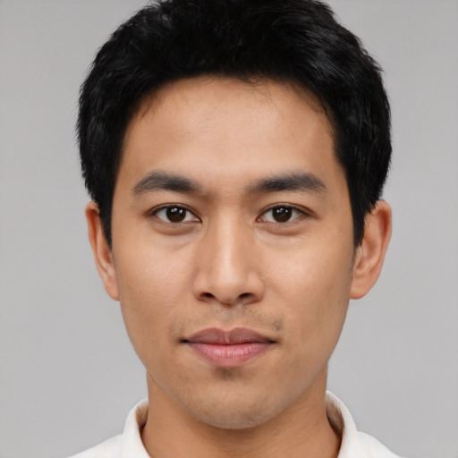 Joyful asian young-adult male with short  black hair and brown eyes