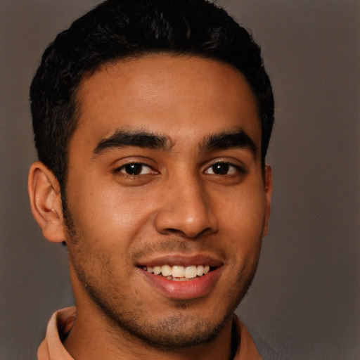 Joyful latino young-adult male with short  black hair and brown eyes