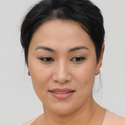 Joyful asian young-adult female with medium  brown hair and brown eyes