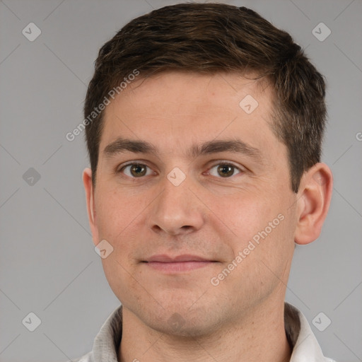 Joyful white young-adult male with short  brown hair and grey eyes