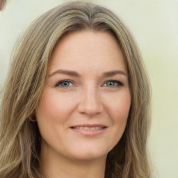 Joyful white young-adult female with long  brown hair and green eyes