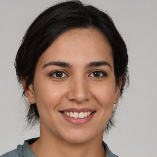 Joyful white young-adult female with medium  brown hair and brown eyes