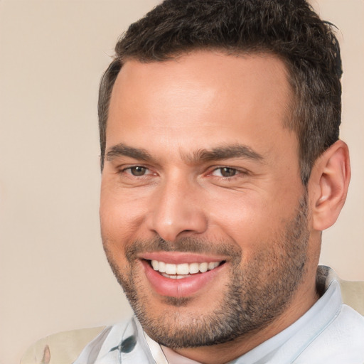 Joyful white adult male with short  brown hair and brown eyes