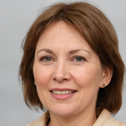 Joyful white adult female with medium  brown hair and brown eyes