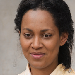 Joyful black adult female with medium  brown hair and brown eyes