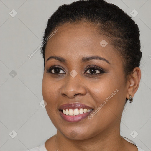 Joyful black young-adult female with short  brown hair and brown eyes