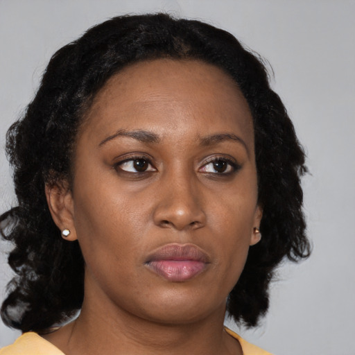 Neutral black adult female with medium  brown hair and brown eyes