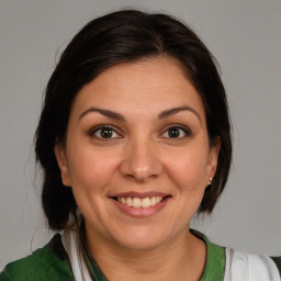 Joyful white adult female with medium  brown hair and brown eyes