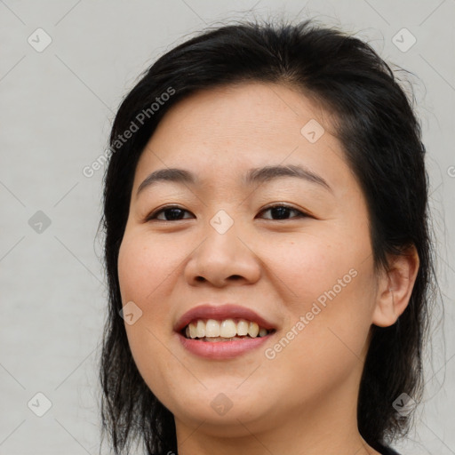 Joyful asian young-adult female with long  brown hair and brown eyes