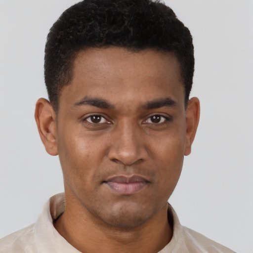 Joyful black young-adult male with short  black hair and brown eyes