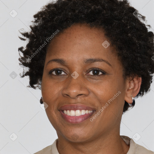 Joyful black adult female with short  brown hair and brown eyes