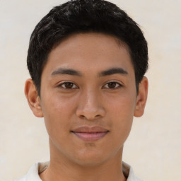 Joyful latino young-adult male with short  brown hair and brown eyes