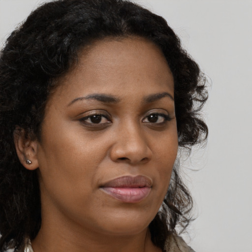 Joyful black young-adult female with long  brown hair and brown eyes