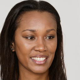 Joyful black young-adult female with long  brown hair and brown eyes