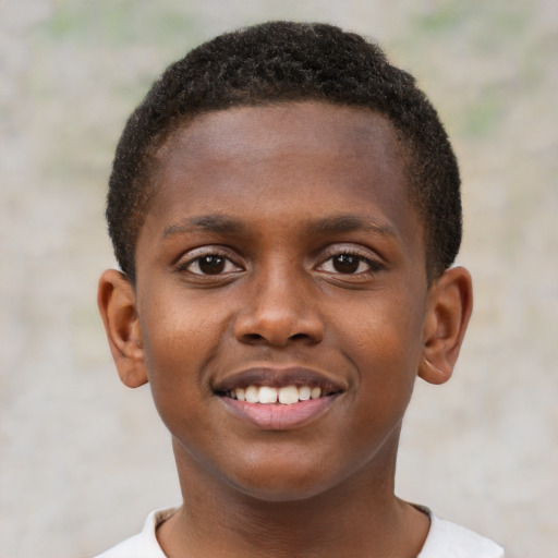 Joyful black child male with short  brown hair and brown eyes