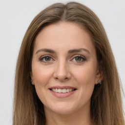 Joyful white young-adult female with long  brown hair and green eyes