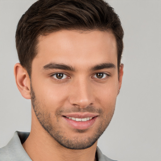 Joyful white young-adult male with short  brown hair and brown eyes