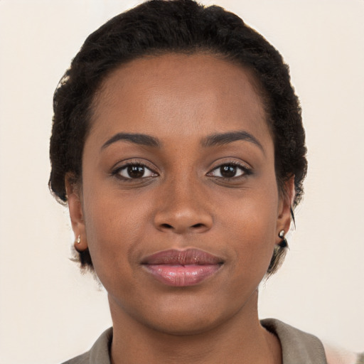 Joyful black young-adult female with short  brown hair and brown eyes