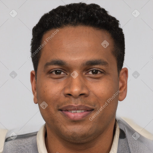 Joyful black young-adult male with short  black hair and brown eyes