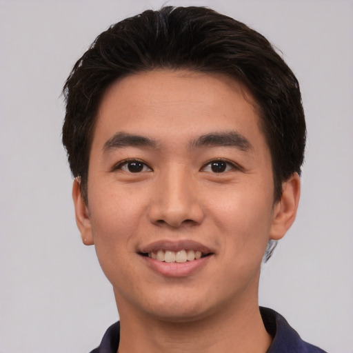 Joyful asian young-adult male with short  brown hair and brown eyes