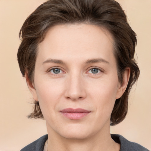 Joyful white young-adult female with medium  brown hair and grey eyes