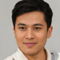 Joyful asian young-adult male with short  brown hair and brown eyes