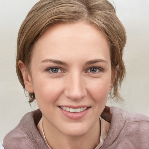 Joyful white young-adult female with medium  brown hair and blue eyes