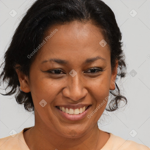 Joyful black adult female with medium  brown hair and brown eyes