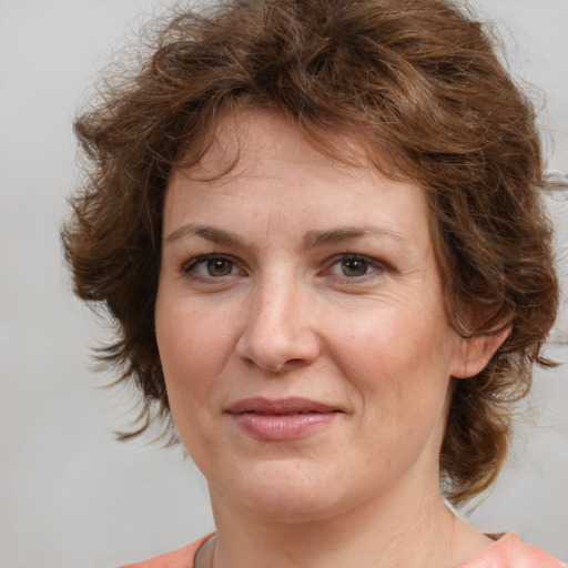 Joyful white adult female with medium  brown hair and brown eyes