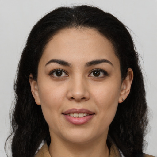 Joyful latino young-adult female with long  brown hair and brown eyes