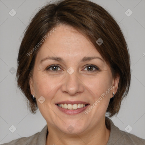 Joyful white adult female with medium  brown hair and brown eyes