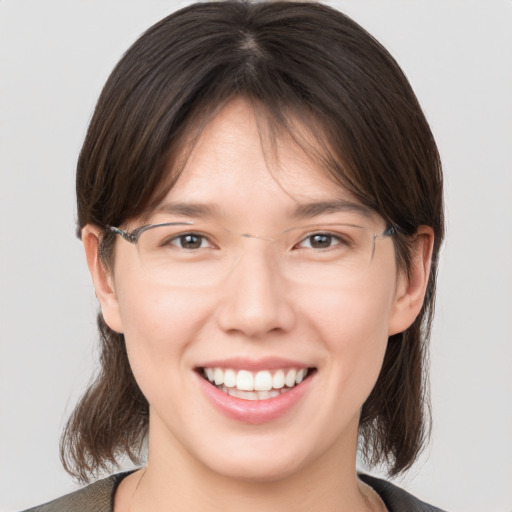 Joyful white young-adult female with medium  brown hair and brown eyes