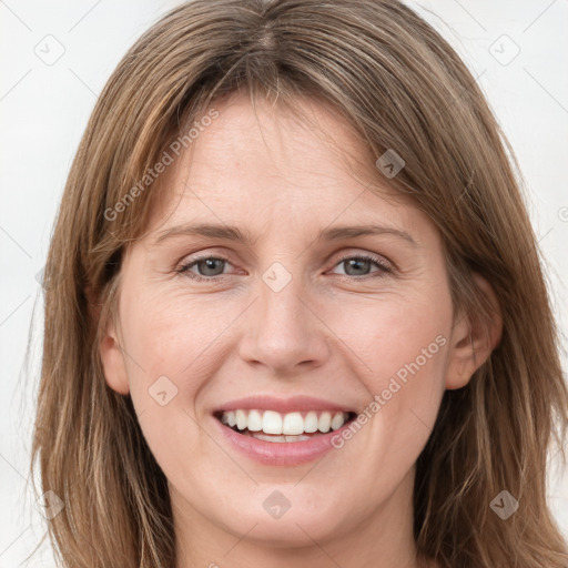 Joyful white young-adult female with long  brown hair and grey eyes