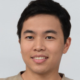 Joyful asian young-adult male with short  brown hair and brown eyes