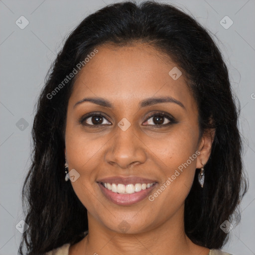 Joyful black young-adult female with long  brown hair and brown eyes