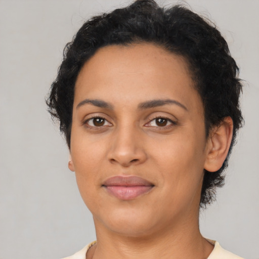 Joyful latino young-adult female with short  black hair and brown eyes