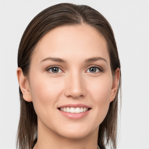 Joyful white young-adult female with long  brown hair and grey eyes