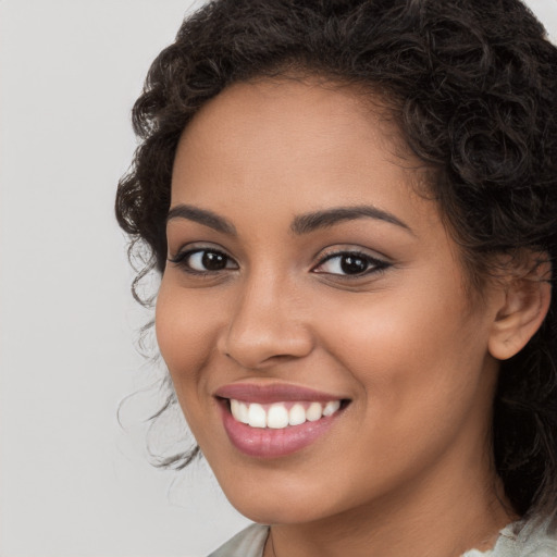 Joyful latino young-adult female with long  brown hair and brown eyes