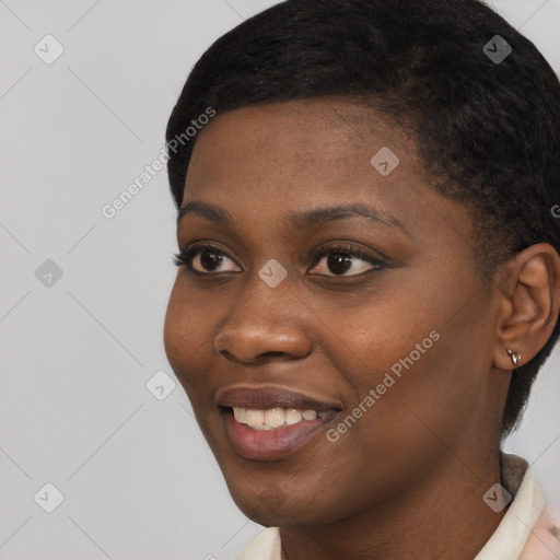 Joyful black young-adult female with short  black hair and brown eyes