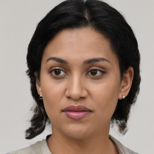 Joyful latino young-adult female with medium  black hair and brown eyes