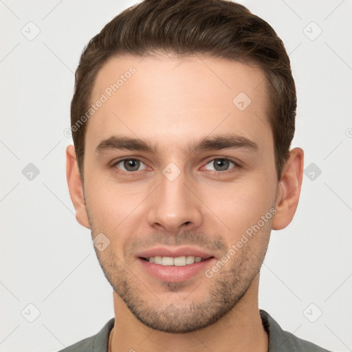 Joyful white young-adult male with short  brown hair and brown eyes