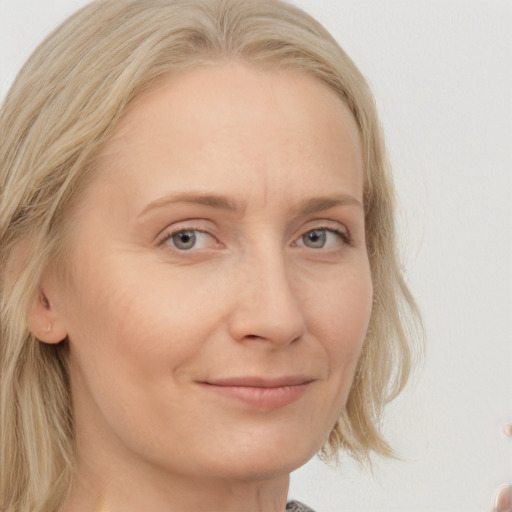 Joyful white young-adult female with medium  blond hair and blue eyes