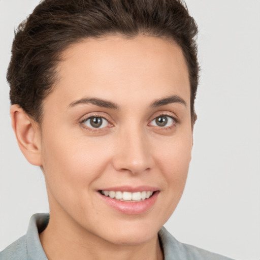 Joyful white young-adult female with short  brown hair and brown eyes