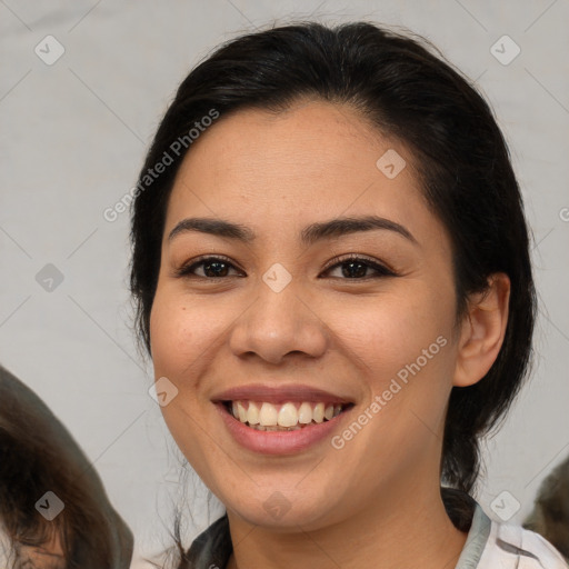 Joyful asian young-adult female with medium  brown hair and brown eyes