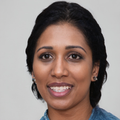 Joyful black young-adult female with medium  black hair and brown eyes