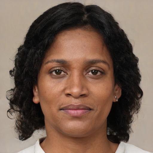 Joyful black young-adult female with medium  brown hair and brown eyes