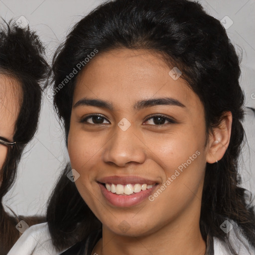 Joyful latino young-adult female with medium  brown hair and brown eyes